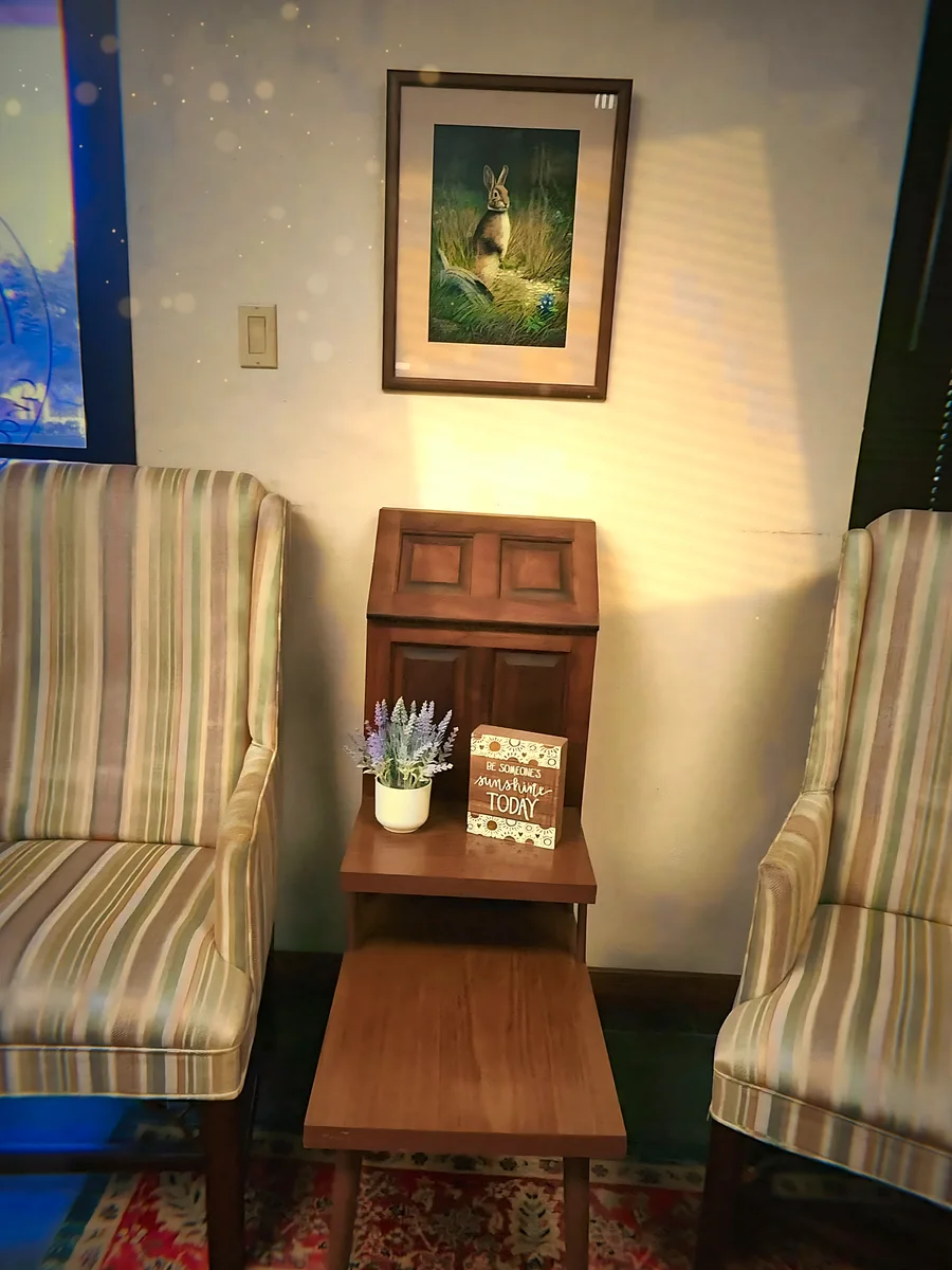 Two striped wingback chairs and a small side table