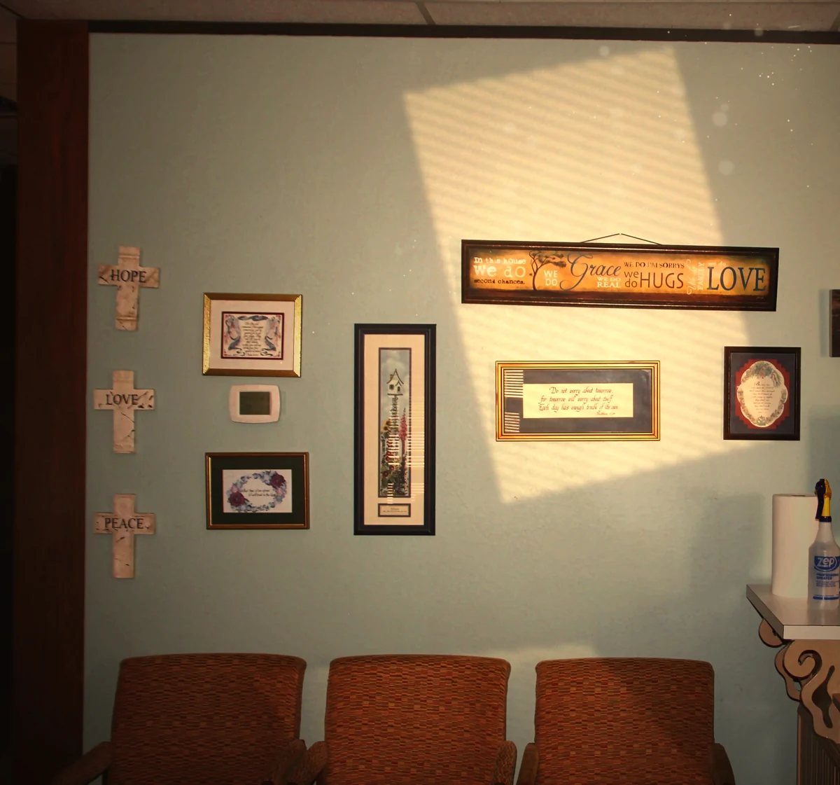 Framed verses and crosses above the waiting chairs