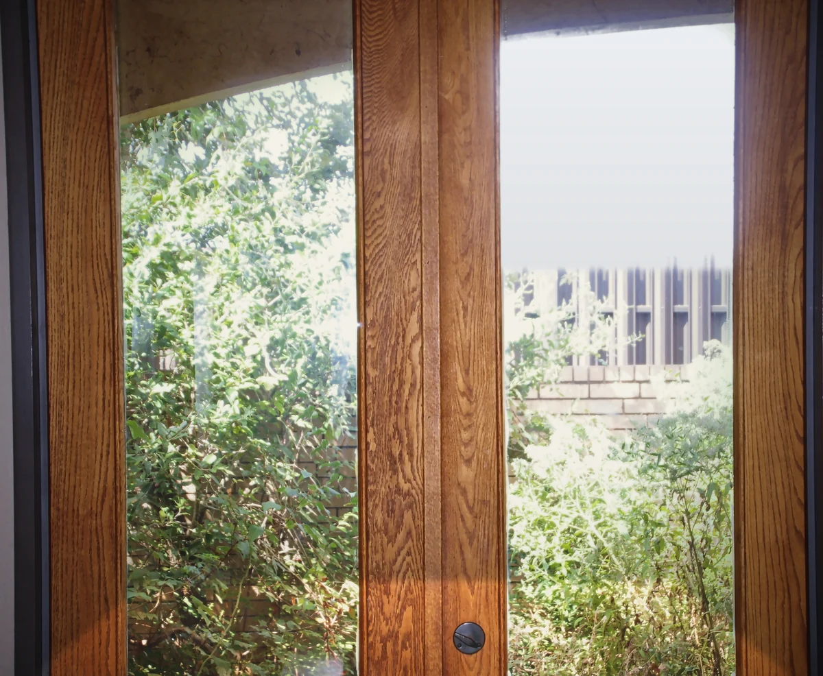 French doors opening onto a green garden