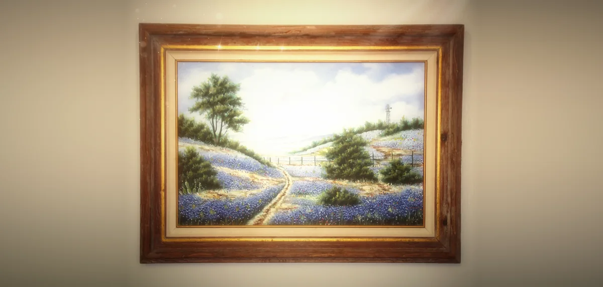 A framed painting of a Texas bluebonnet field