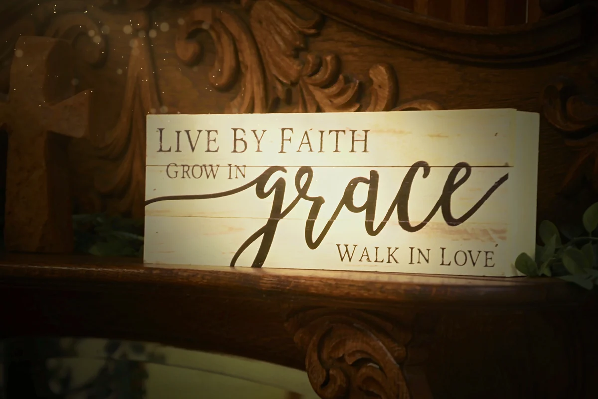 The Live by Faith, Grow in Grace, Walk in Love sign in afternoon sun