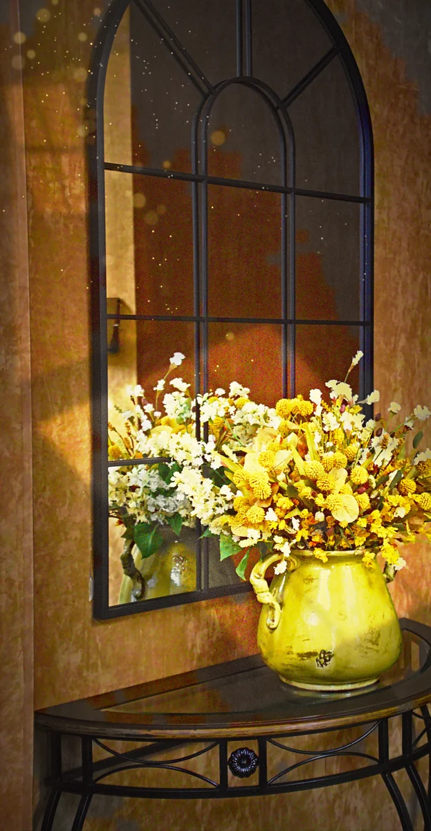 A sunlit bouquet in a green pitcher before an arched mirror